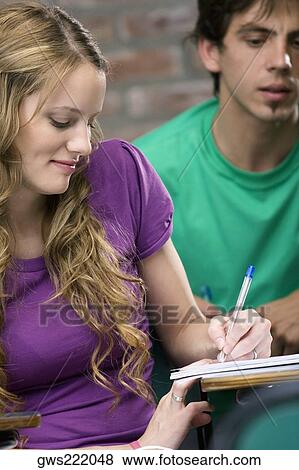 Two university students studying in a classroom View Large Photo Image Stock Photo - Two university students studying in a classroom. Fotosearch