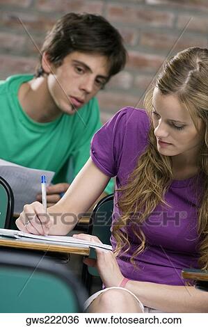 Two university students studying in a classroom View Large Photo Image Stock Photograph - Two university students studying in a classroom. Fotosearch