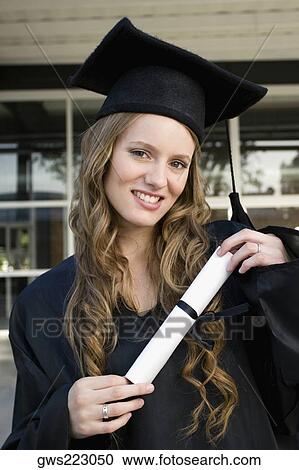 Portrait of a female graduate holding her degree and smiling View Large Photo Image Stock Image - Portrait of a female graduate holding her degree and smiling. Fotosearch
