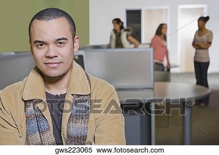 Stock Photography - Portrait of a young man in a computer lab. Fotosearch