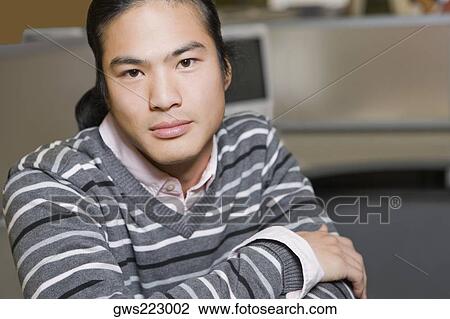 Stock Image - Portrait of a young man thinking. Fotosearch