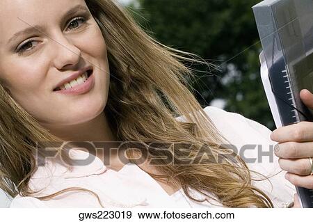 Portrait of a young woman smiling View Large Photo Image Stock Photo - Portrait of a young woman smiling. Fotosearch