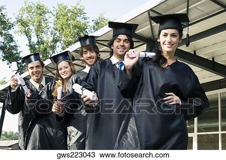 Portrait of graduate students holding their degrees and smiling View Large Photo Image Stock Image - Portrait of graduate students holding their degrees and smiling. Fotosearch