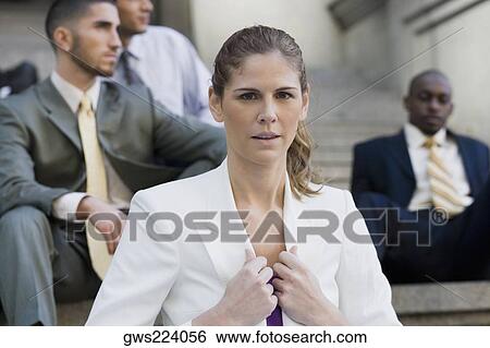 Stock Photograph - Close-up of a businesswoman holding the lapel of her coat. Fotosearch