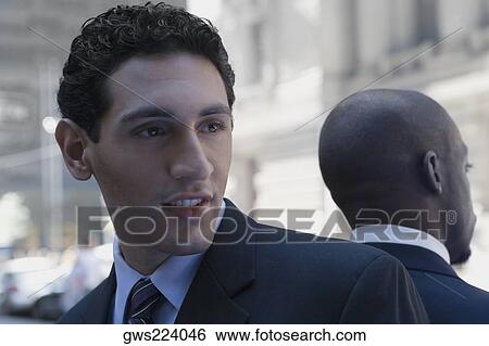 Close-up of two businessmen back to back View Large Photo Image Stock Photograph - Close-up of two businessmen back to back. Fotosearch