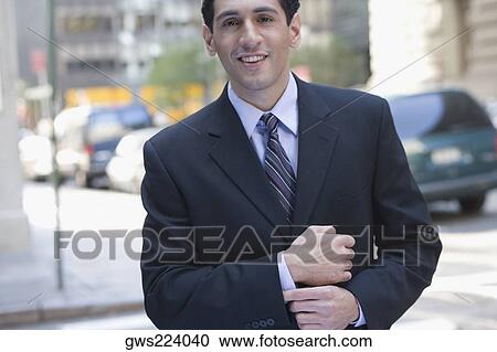 Portrait of a businessman smiling View Large Photo Image Stock Image - Portrait of a businessman smiling. Fotosearch