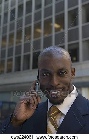 Portrait of a businessman talking on a mobile phone and smiling View Large Photo Image Stock Image - Portrait of a businessman talking on a mobile phone and smiling. Fotosearch
