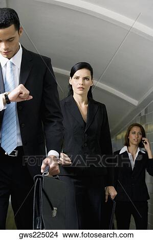 Business executives walking in a subway View Large Photo Image Picture - Business executives walking in a subway. Fotosearch