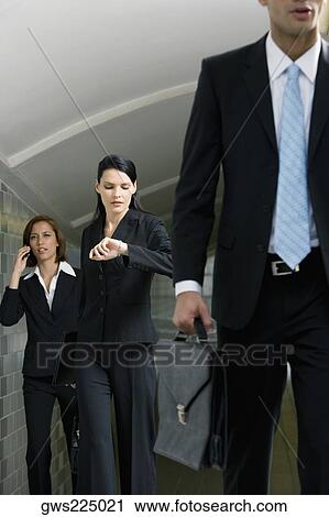 Business executives walking in a subway View Large Photo Image Stock Image - Business executives walking in a subway. Fotosearch