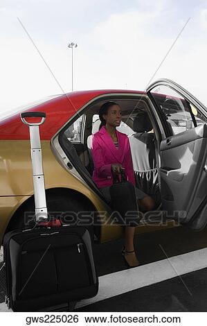Stock Photograph - Businesswoman sitting in a taxi. Fotosearch