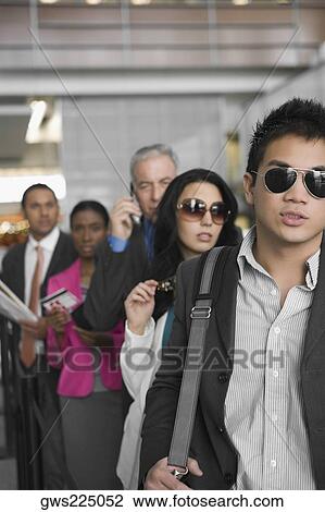 Five business executives standing in a row at an airport View Large Photo Image Stock Image - Five business executives standing in a row at an airport. Fotosearch