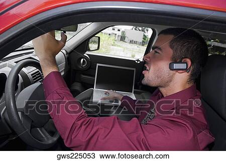 Side profile of a businessman sitting in a car and using a laptop View Large Photo Image Stock Image - Side profile of a businessman sitting in a car and using a laptop. Fotosearch