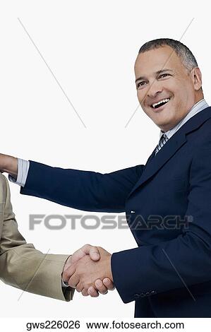 Stock Photograph - Businessman shaking hands with another businessman. Fotosearch