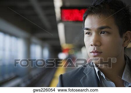 Close-up of a businessman at a subway station View Large Photo Image Picture - Close-up of a businessman at a subway station. Fotosearch
