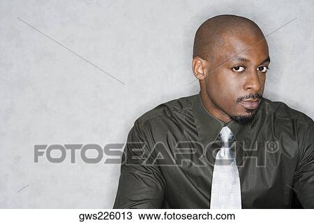Stock Image - Portrait of a businessman looking serious. Fotosearch