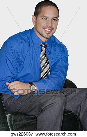 Portrait of a businessman sitting on a chair and smiling View Large Photo Image Stock Photo - Portrait of a businessman sitting on a chair and smiling. Fotosearch