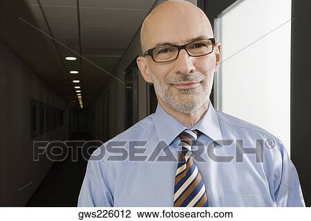 Portrait of a businessman smiling View Large Photo Image Stock Image - Portrait of a businessman smiling. Fotosearch