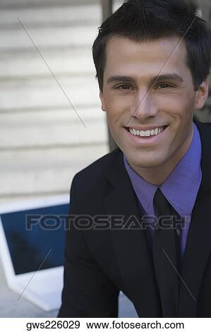 Portrait of a businessman smiling View Large Photo Image Stock Photo - Portrait of a businessman smiling. Fotosearch