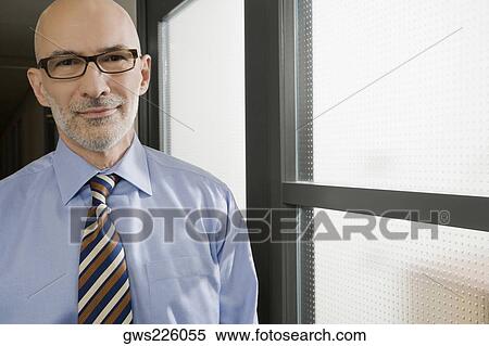 Portrait of a businessman smiling View Large Photo Image Stock Photography - Portrait of a businessman smiling. Fotosearch