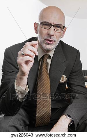 Stock Image - Portrait of a businessman thinking. Fotosearch