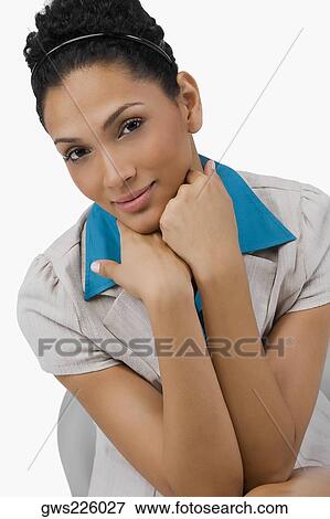 Portrait of a businesswoman sitting on a chair with her hand on her chin View Large Photo Image Stock Photo - Portrait of a businesswoman sitting on a chair with her hand on her chin. Fotosearch