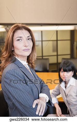 Picture - Portrait of a two businesswomen in a board room. Fotosearch