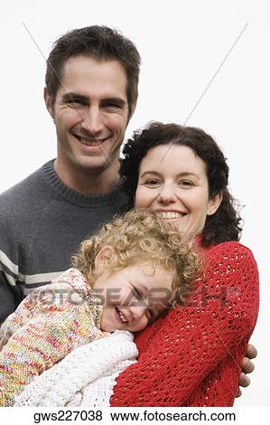 Portrait of a couple smiling with their daughter View Large Photo Image Stock Photo - Portrait of a couple smiling with their daughter. Fotosearch