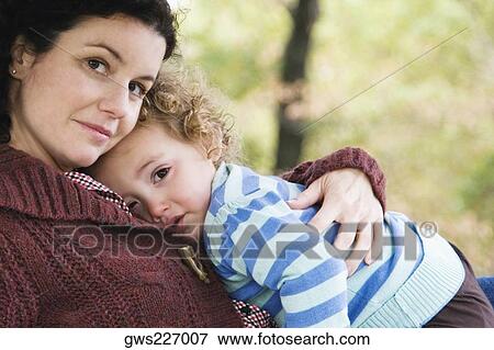 Portrait of a mid adult woman hugging her daughter View Large Photo Image Stock Photo - Portrait of a mid adult woman hugging her daughter. Fotosearch
