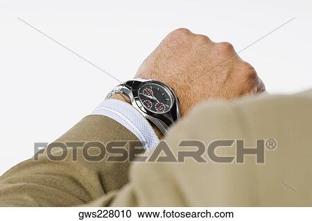 Close-up of a businessman checking the time View Large Photo Image Stock Image - Close-up of a businessman checking the time. Fotosearch