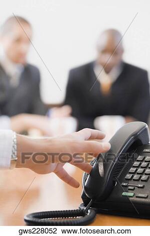 Close-up of a businesswoman's hand reaching to a conference phone receiver View Large Photo Image Stock Image - Close-up of a businesswoman's hand reaching to a conference phone receiver. Fotosearch