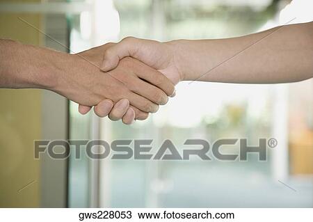 Close-up of a man and a woman shaking hands View Large Photo Image Stock Image - Close-up of a man and a woman shaking hands. Fotosearch