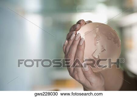 Close-up of a person's hand holding a globe View Large Photo Image Stock Image - Close-up of a person's hand holding a globe. Fotosearch