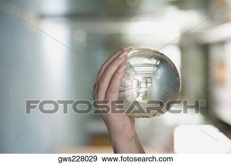 Close-up of a person's hand holding a crystal ball View Large Photo Image Stock Photo - Close-up of a person's hand holding a crystal ball. Fotosearch