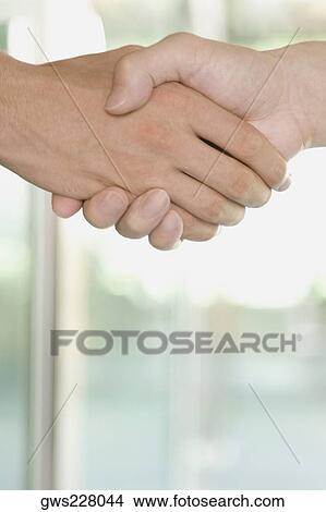 Close-up of two people shaking their hands View Large Photo Image Picture - Close-up of two people shaking their hands. Fotosearch