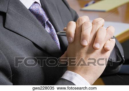 Mid section view of a man with his hands clasped View Large Photo Image Stock Photography - Mid section view of a man with his hands clasped. Fotosearch