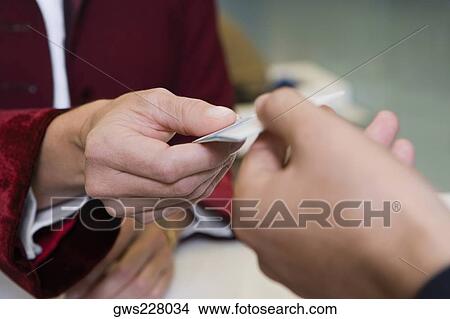 Receptionist's hand giving the cardkey to a customer View Large Photo Image Picture - Receptionist's hand giving the cardkey to a customer. Fotosearch