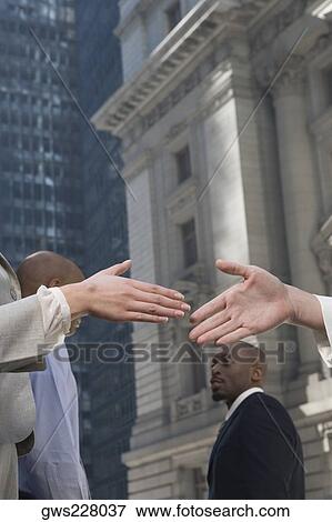 Stock Photo - Two business executives shaking hands. Fotosearch
