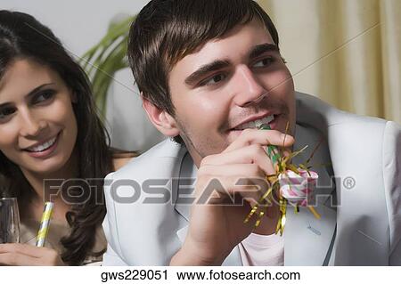 Close-up of a young couple enjoying a birthday party View Large Photo Image Stock Image - Close-up of a young couple enjoying a birthday party. Fotosearch