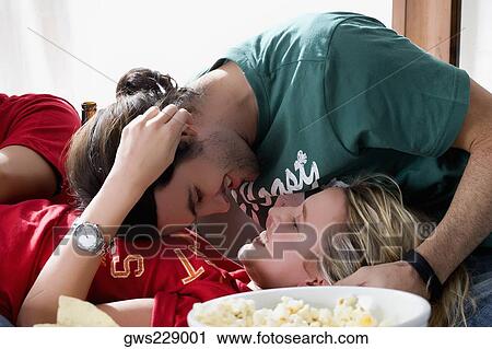Close-up of a young couple romancing View Large Photo Image Stock Image - Close-up of a young couple romancing. Fotosearch