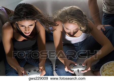 High angle view of two young women playing video game View Large Photo Image Stock Photo - High angle view of two young women playing video game. Fotosearch