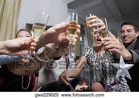Low angle view of a young woman celebrating birthday with her friends View Large Photo Image Stock Image - Low angle view of a young woman celebrating birthday with her friends. Fotosearch
