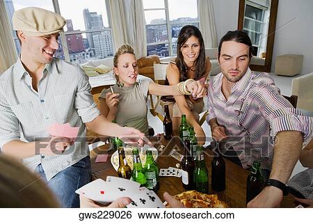 Young man with her friends playing cards View Large Photo Image Stock Photograph - Young man with her friends playing cards. Fotosearch