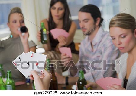 Young man with her friends playing cards View Large Photo Image Stock Photography - Young man with her friends playing cards. Fotosearch
