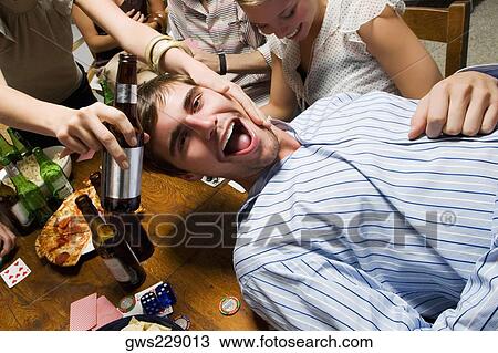 Young man with his friends enjoying a party View Large Photo Image Stock Image - Young man with his friends enjoying a party. Fotosearch