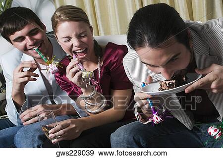 Young man with his friends enjoying a birthday party View Large Photo Image Stock Photo - Young man with his friends enjoying a birthday party. Fotosearch