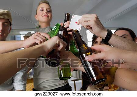 Young woman and her friends toasting with beers View Large Photo Image Stock Photo - Young woman and her friends toasting with beers. Fotosearch