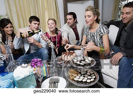 Young woman celebrating birthday with her friends View Large Photo Image Stock Image - Young woman celebrating birthday with her friends. Fotosearch