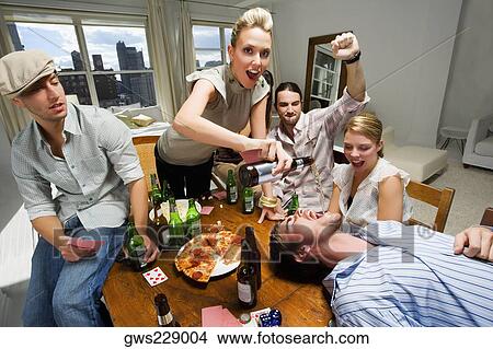 Young woman with her friends enjoying a party View Large Photo Image Picture - Young woman with her friends enjoying a party. Fotosearch