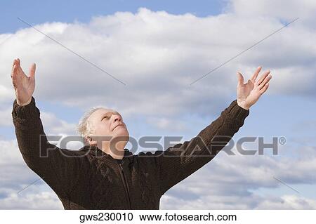Close-up of a senior man with his arms raised View Large Photo Image Stock Image - Close-up of a senior man with his arms raised. Fotosearch