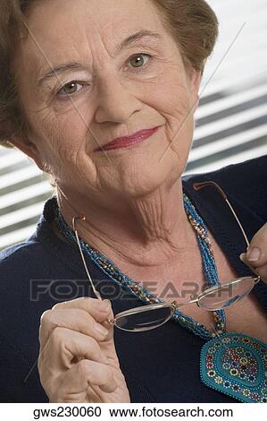 Close-up of a senior woman smiling View Large Photo Image Stock Image - Close-up of a senior woman smiling. Fotosearch